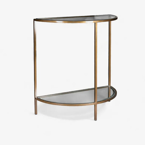 Small curved table with glass top and bronze metal frame on a white background