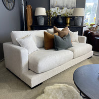 White sofa with colorful pillows in a living room setting