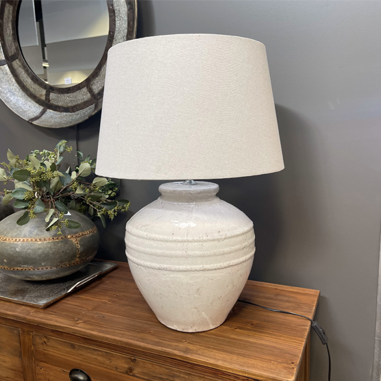 A statement lamp with terracotta base glazed in an antique finish.