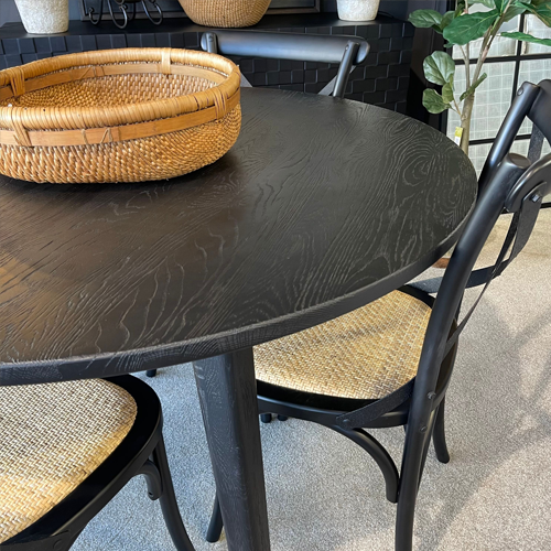 round black dining table with black chairs