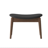 Stool with black seat and wooden legs on a white background
