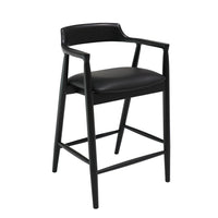 Black bar stool with cushioned seat on a white background