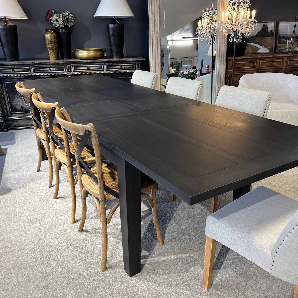 Dining room with a dark wooden table and various chairs.