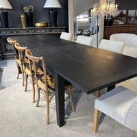 Dining room with a dark wooden table and various chairs.