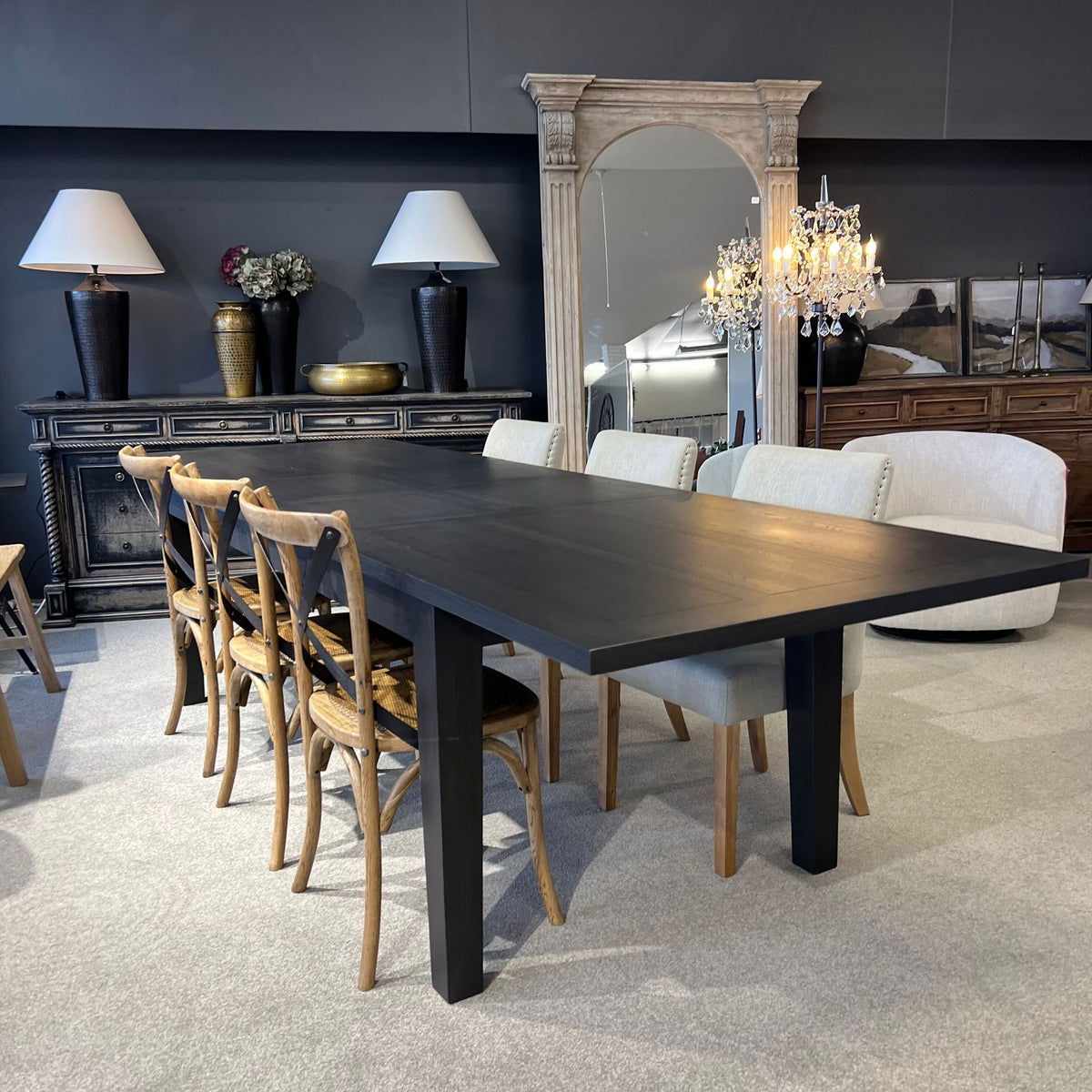 Dining room with a black table and chairs in a stylish interior setting.