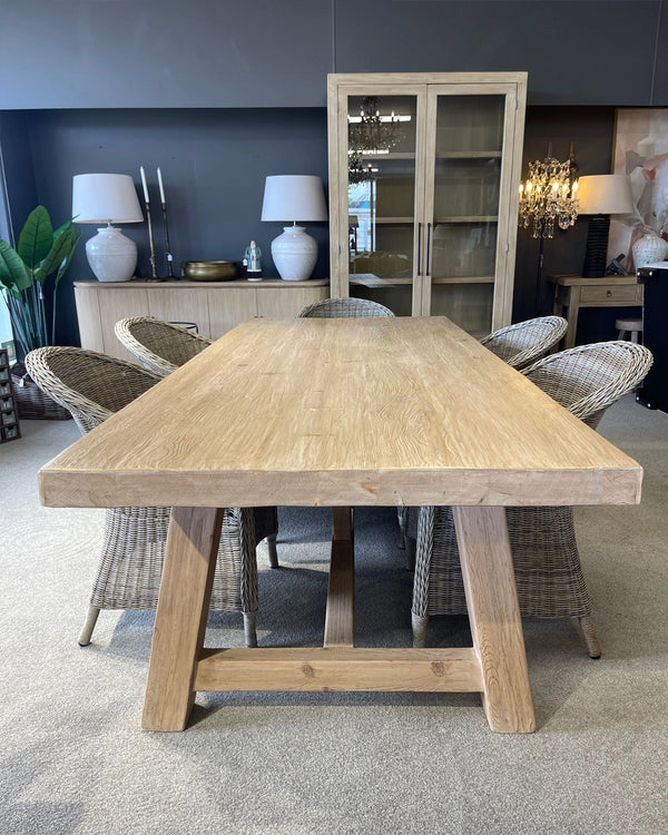 Wooden dining table with chairs in a room setting