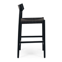 Black bar stool with woven seat on a white background