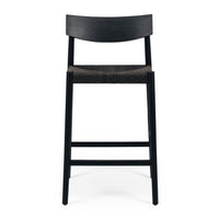 Black bar stool with woven seat on a white background