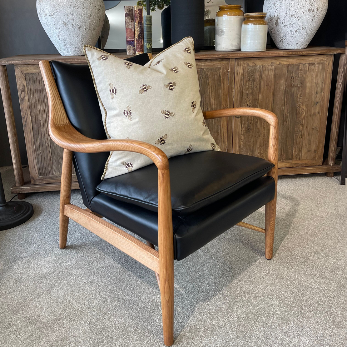 Black leather armchair with wooden arms