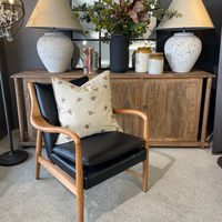 Black leather armchair with wooden arms

