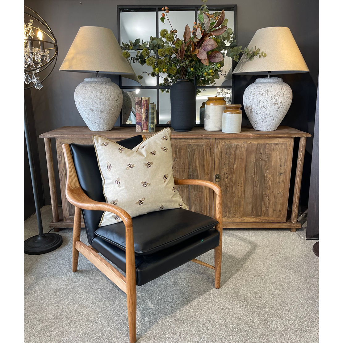 Black leather armchair with wooden arms