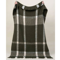Plaid blanket with green, and white pattern held up against a plain background