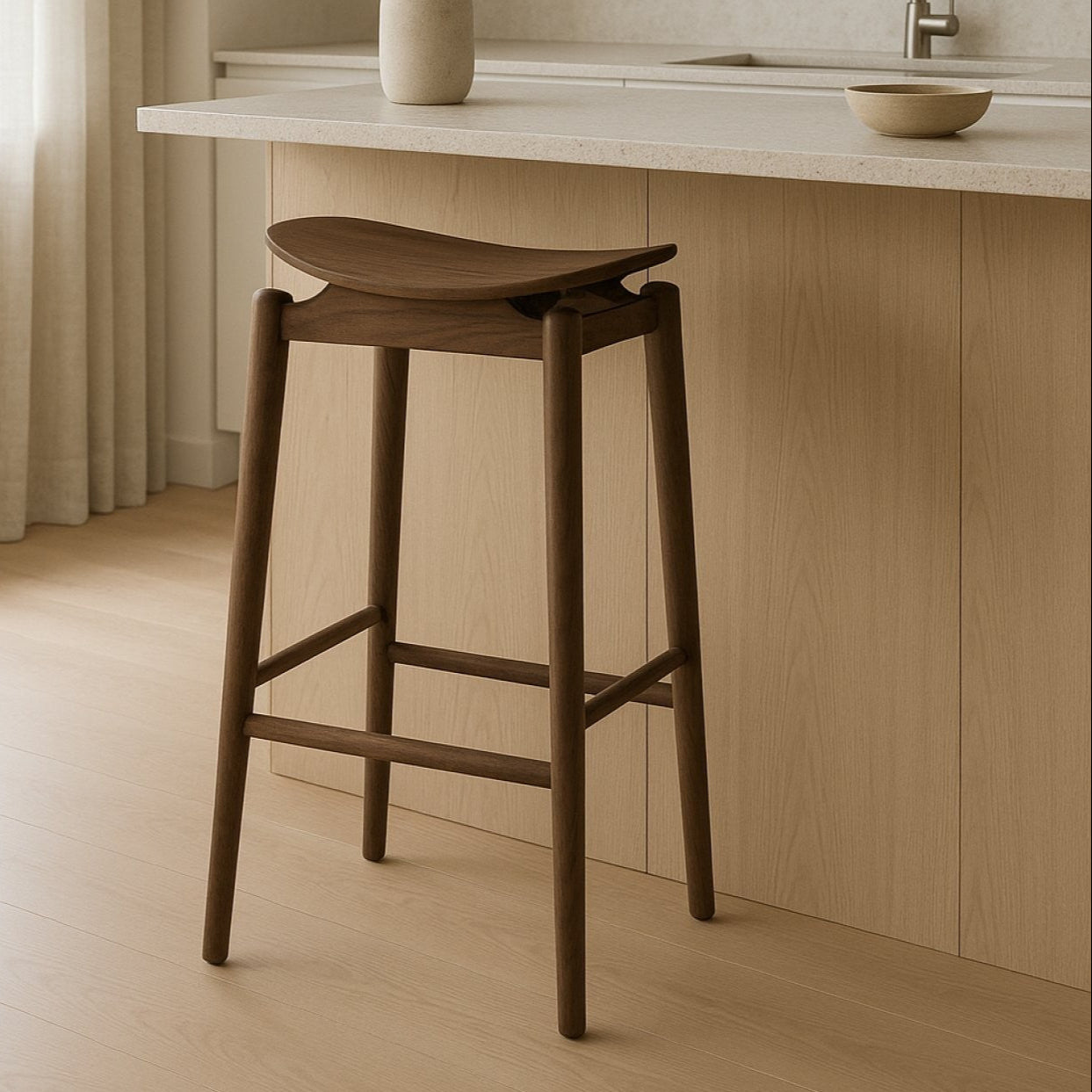 Wooden bar stool in a kitchen setting with light wood cabinets and a neutral color palette.