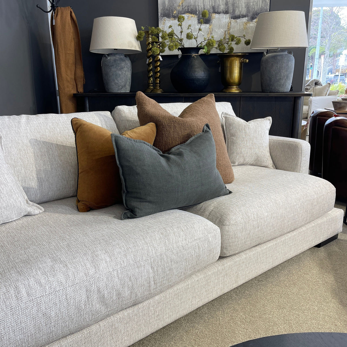 natural sofa with colorful pillows in a living room setting