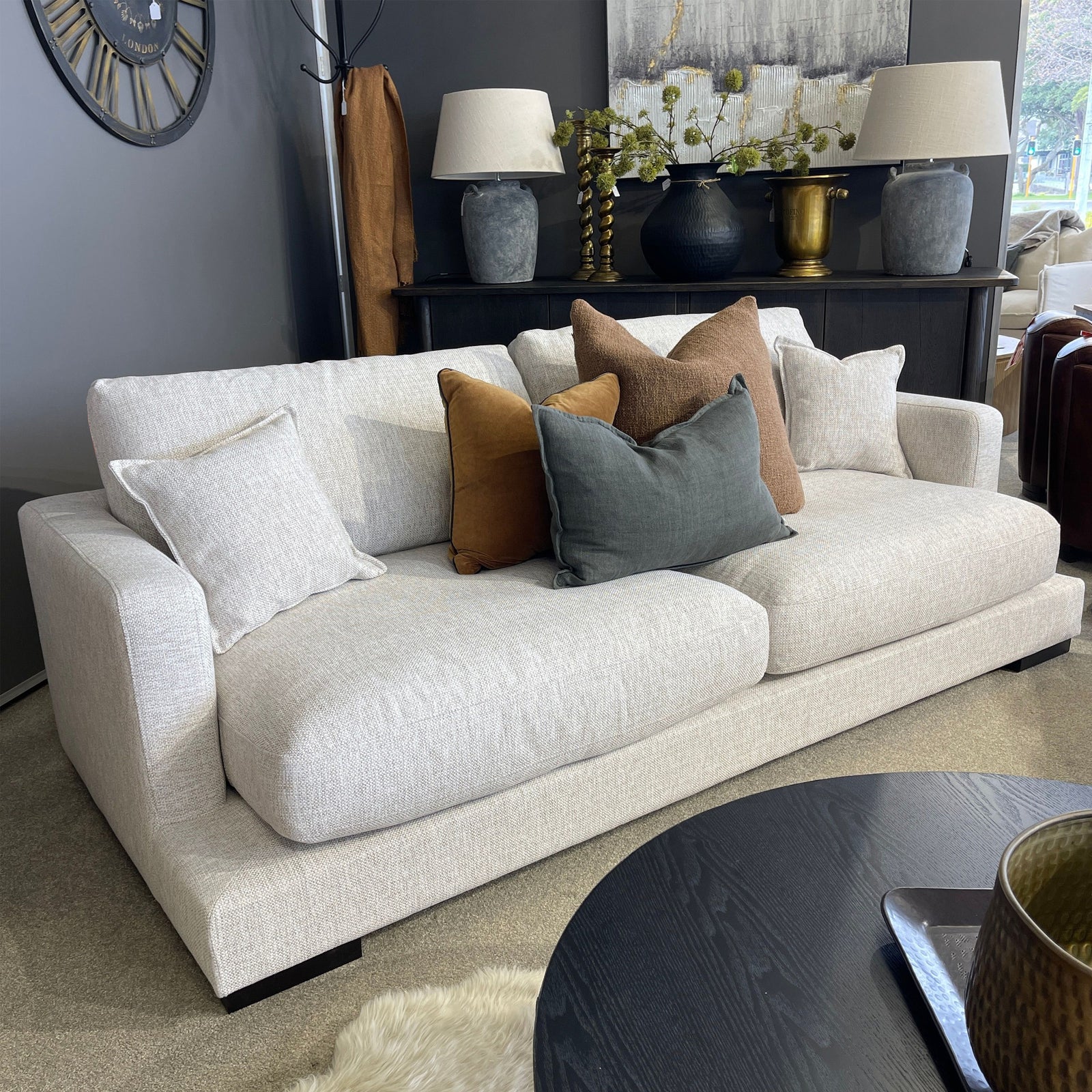 Beige sofa with colorful cushions in a living room setting.