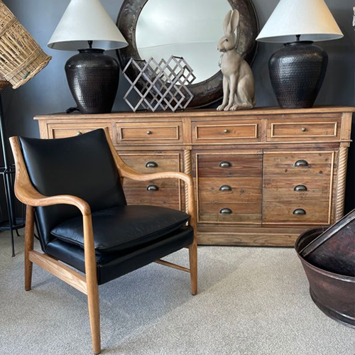 Black leather armchair with wooden arms