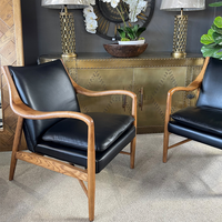 Black leather armchair with wooden arms