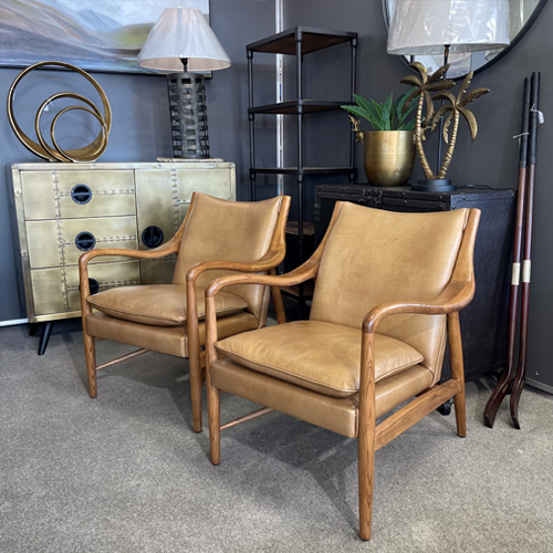 Armchair in tan leather with timber arms