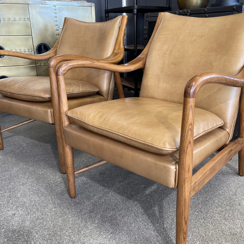 Armchair in tan leather with timber arms